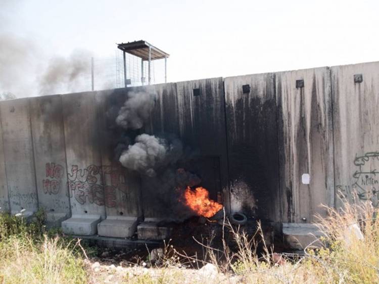 Fire at the Apartheid wall away from the main protest